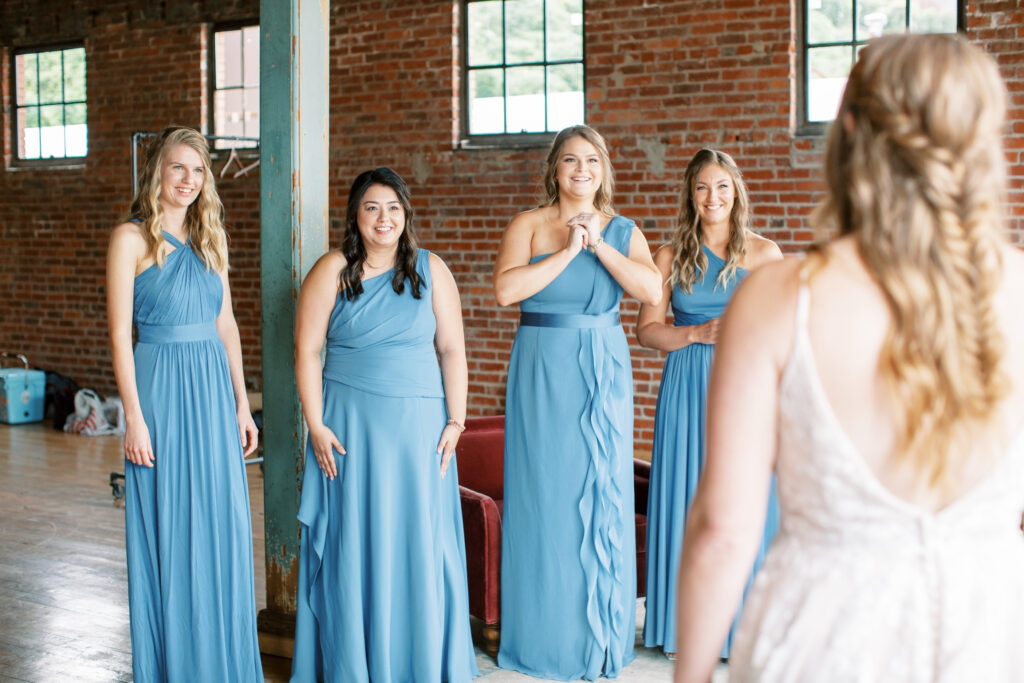 Bride reveals her dress to her bridesmaids
