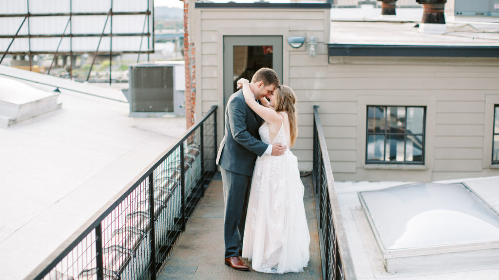 Couple poses on top of the standard knoxville wedding venue after their ceremony downtown