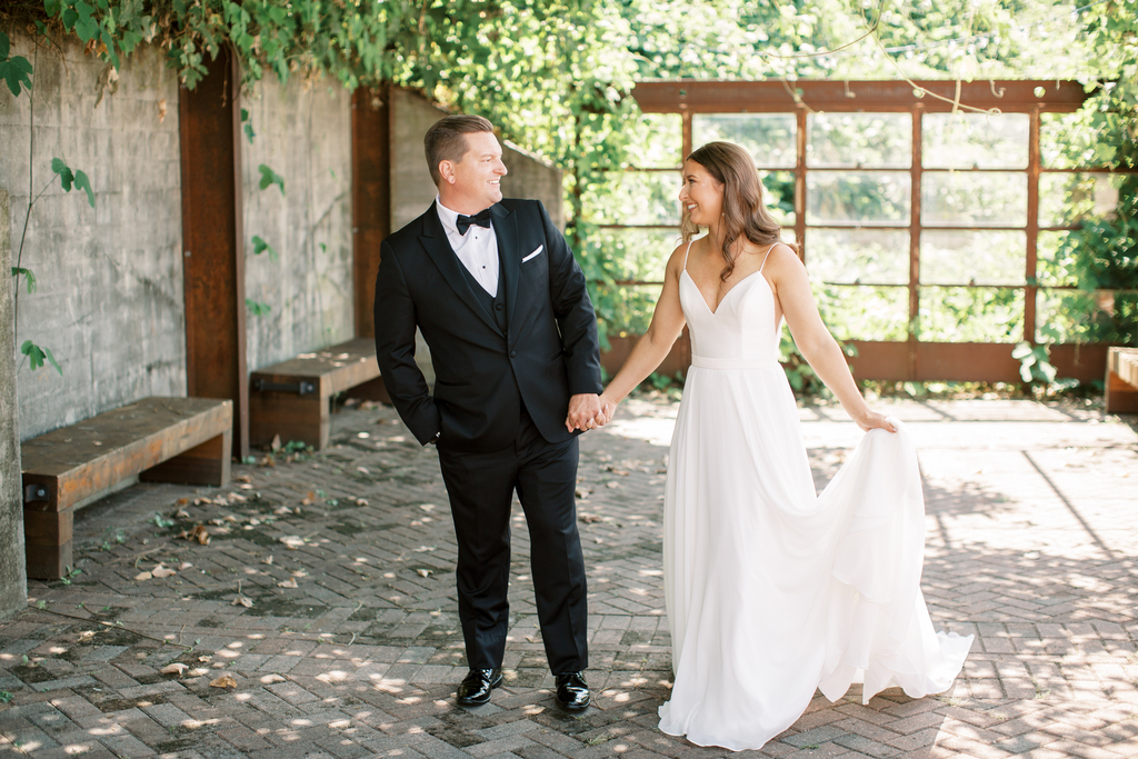 Bride and Groom holding hands as they take photos before their ceremony starts at the downtown wedding venue The Standard Knoxville